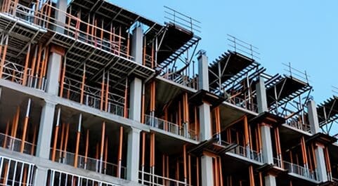 A building scaffolding on the side of it.